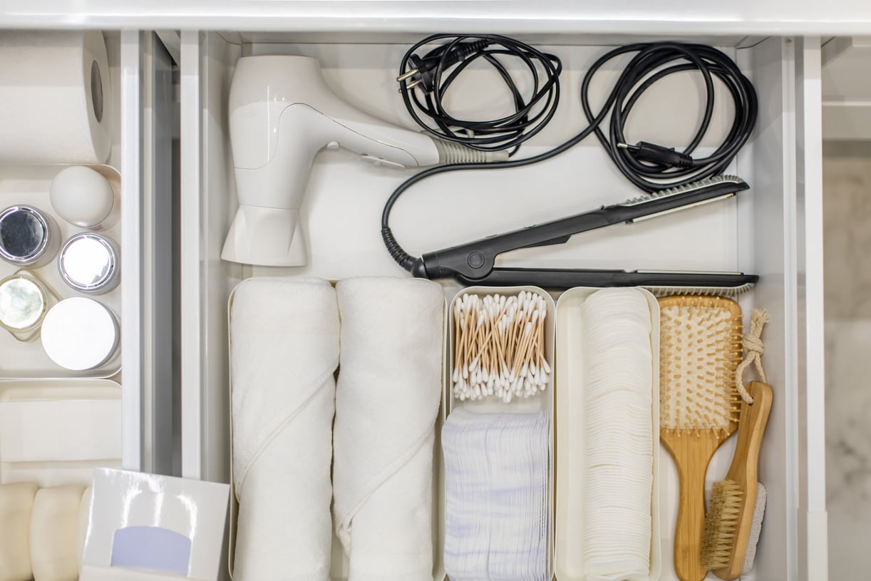 Bathroom under sink organizer drawers with neatly placed bath amenities and toiletries